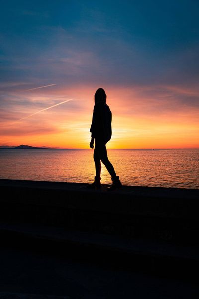 walking as the sun sets in the background